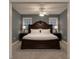 Cozy bedroom featuring a large decorative bed frame, bedside lamps, and neutral carpet at 2431 Weatherstone Se Cir, Conyers, GA 30094