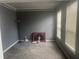 View of a carpeted bedroom with painted gray walls and two windows that provide natural light at 2431 Weatherstone Se Cir, Conyers, GA 30094