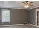 Bedroom with ceiling fan, neutral paint, window with blinds, and carpet at 2431 Weatherstone Se Cir, Conyers, GA 30094