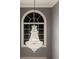 Elegant crystal chandelier hanging in a room with a grey wall at 2431 Weatherstone Se Cir, Conyers, GA 30094