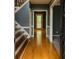 Inviting foyer with hardwood floors, staircase, and doorway leading to the rear patio at 2431 Weatherstone Se Cir, Conyers, GA 30094