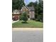 Beautiful two-story brick home with manicured lawn and mature trees providing privacy at 2431 Weatherstone Se Cir, Conyers, GA 30094