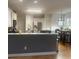 Bright kitchen featuring a breakfast bar, white cabinets, and hardwood floors at 2431 Weatherstone Se Cir, Conyers, GA 30094