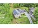 An aerial view showing a home with lush landscaping, a long driveway, and a detached garage, offering privacy and space at 2657 Langland Ne Ct, Atlanta, GA 30345