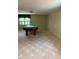 Spacious carpeted basement with a pool table, large window and neutral walls at 2657 Langland Ne Ct, Atlanta, GA 30345