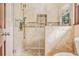 Newly renovated shower with tiled walls, a glass door, and a rain shower head at 2657 Langland Ne Ct, Atlanta, GA 30345