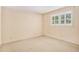 Bright bedroom featuring a large window with shutter blinds and neutral paint at 2657 Langland Ne Ct, Atlanta, GA 30345