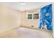 Bedroom with custom space themed mural, ample natural light, and neutral walls at 2657 Langland Ne Ct, Atlanta, GA 30345