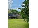 Back exterior view of home and yard with screened porch and dark shingled roof at 2657 Langland Ne Ct, Atlanta, GA 30345