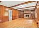 Spacious living room with wood paneling, fireplace with built-ins, and hardwood floors at 2657 Langland Ne Ct, Atlanta, GA 30345