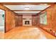 Living room with wood paneling, fireplace with built-ins, hardwood floors, and a large window at 2657 Langland Ne Ct, Atlanta, GA 30345