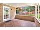 Enclosed sunroom featuring brick walls and outdoor view of the backyard at 2657 Langland Ne Ct, Atlanta, GA 30345