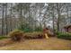 Spacious backyard featuring a play set and privacy landscaping at 308 Tulipwood Sw Cir, Conyers, GA 30094