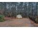 Backyard view featuring a storage shed surrounded by trees at 308 Tulipwood Sw Cir, Conyers, GA 30094