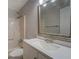 Bathroom with shower over tub, toilet, and vanity with white countertop and shaker cabinet at 308 Tulipwood Sw Cir, Conyers, GA 30094