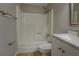 Bright bathroom features a white shower-tub combo, toilet, sink and mirrored vanity at 308 Tulipwood Sw Cir, Conyers, GA 30094