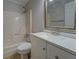 Bathroom featuring a white vanity with framed mirror and tub-shower combo at 308 Tulipwood Sw Cir, Conyers, GA 30094