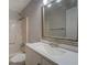 Bright bathroom featuring a white shower-tub combo, toilet, sink and a mirrored vanity at 308 Tulipwood Sw Cir, Conyers, GA 30094