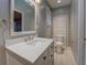 Bright bathroom featuring a modern vanity with marble countertop and a large mirror at 308 Tulipwood Sw Cir, Conyers, GA 30094