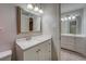 Bathroom featuring a double vanity with white cabinets, and framed mirror, neutral paint at 308 Tulipwood Sw Cir, Conyers, GA 30094