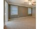 Spacious bedroom featuring neutral walls, plush carpeting, and a ceiling fan for added comfort at 308 Tulipwood Sw Cir, Conyers, GA 30094
