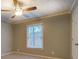Bedroom with carpet, natural light, and ceiling fan, complemented by neutral walls and white trim at 308 Tulipwood Sw Cir, Conyers, GA 30094