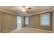 Cozy bedroom featuring two large windows, soft carpeting and a doorway that leads to the bathroom at 308 Tulipwood Sw Cir, Conyers, GA 30094