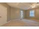 Large carpeted bedroom with a ceiling fan, window and neutral paint at 308 Tulipwood Sw Cir, Conyers, GA 30094