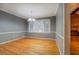 Cozy dining room with crown molding, natural light, and hardwood flooring at 308 Tulipwood Sw Cir, Conyers, GA 30094
