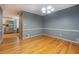 Cozy dining room showcasing hardwood floors, crown molding, and modern lighting at 308 Tulipwood Sw Cir, Conyers, GA 30094