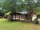 Charming brick home with attached garage and back yard with patio, greenery, and playground at 308 Tulipwood Sw Cir, Conyers, GA 30094