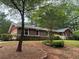 Charming brick home featuring a landscaped front yard and attached garage at 308 Tulipwood Sw Cir, Conyers, GA 30094