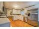 Beautiful kitchen with stainless steel appliances, white cabinets, and stone backsplash at 308 Tulipwood Sw Cir, Conyers, GA 30094