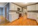 Modern kitchen with stainless steel appliances, white cabinets, and hardwood floors at 308 Tulipwood Sw Cir, Conyers, GA 30094