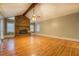 Spacious living room with hardwood floors, brick fireplace, and beamed ceilings at 308 Tulipwood Sw Cir, Conyers, GA 30094