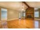 Spacious living room featuring a brick fireplace and beautiful hardwood floors at 308 Tulipwood Sw Cir, Conyers, GA 30094