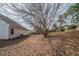 Spacious backyard covered in foliage, with a tree and view of the side of the home at 4932 Wilkins Station Dr, Decatur, GA 30035