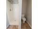 Shower and toilet in a bathroom with neutral finishes and flooring at 4932 Wilkins Station Dr, Decatur, GA 30035