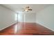 Spacious primary bedroom featuring wood floors, neutral walls, ceiling fan, and a window at 4932 Wilkins Station Dr, Decatur, GA 30035