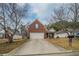 Charming single-Gathering home featuring a brick facade, well-manicured lawn, and attached two-car garage at 4932 Wilkins Station Dr, Decatur, GA 30035