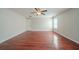 Bright living room with a ceiling fan and lustrous hardwood floors at 4932 Wilkins Station Dr, Decatur, GA 30035