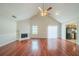 Spacious living room with hardwood floors, a fireplace, and abundant natural light at 4932 Wilkins Station Dr, Decatur, GA 30035