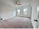 Bright bedroom featuring neutral carpeting, a ceiling fan, and two large windows at 532 Healy Dr # 61, Cumming, GA 30040