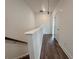 Hallway with wood-look flooring, white walls, and white baseboards at 532 Healy Dr # 61, Cumming, GA 30040