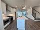 Spacious kitchen featuring stainless steel appliances, large island with quartz countertops, and subway tile backsplash at 532 Healy Dr # 61, Cumming, GA 30040