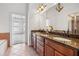 Bathroom features a granite countertop vanity with double sinks, tile floors and a glass shower at 911 Telfair Close, Sandy Springs, GA 30350