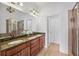 Bathroom featuring granite countertop vanity with double sinks, shower with glass door at 911 Telfair Close, Sandy Springs, GA 30350