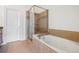 Bathroom featuring a soaking tub with jets, tiled floor, and a glass shower at 911 Telfair Close, Sandy Springs, GA 30350