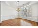 Spacious dining room boasting hardwood floors, wainscoting, and a large window for natural light at 911 Telfair Close, Sandy Springs, GA 30350