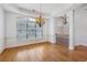 Bright dining room with hardwood floors, a stylish chandelier, and large windows at 911 Telfair Close, Sandy Springs, GA 30350